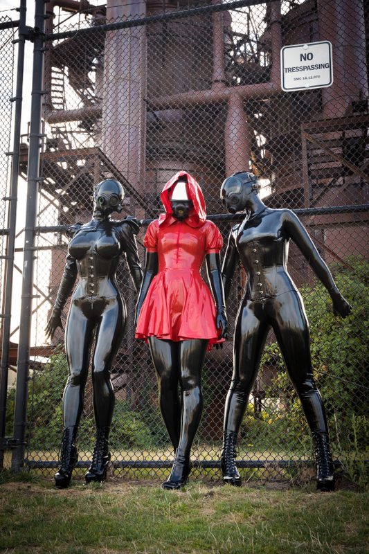 A sexy photograph of Vespa, Rope Candy & Nico, in black & red latex. Tagged with: gasmask & in public. Posted September 2017.