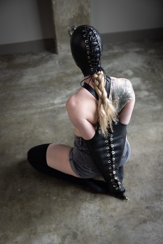A sexy photograph of Charlee showing bare skin. Tagged with: leather & armbinder. Posted June 2021.