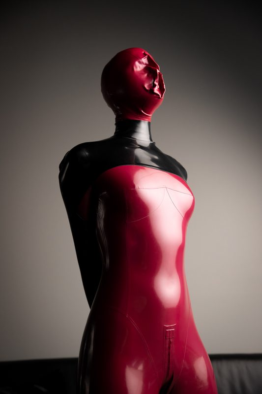 A sexy photograph of Mbot in red latex. Tagged with: armbinder. Posted October 2019.