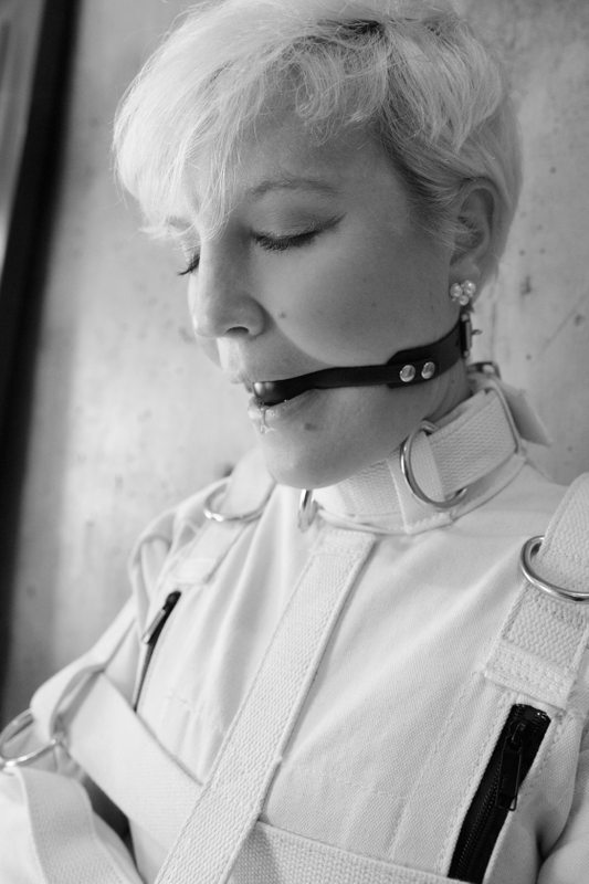 A photo album of Nico in white, black & transparent leather. Tagged with: leather, armbinder, straitjacket, vacuum bondage, gagged, cage & gasmask. Posted February 2019.