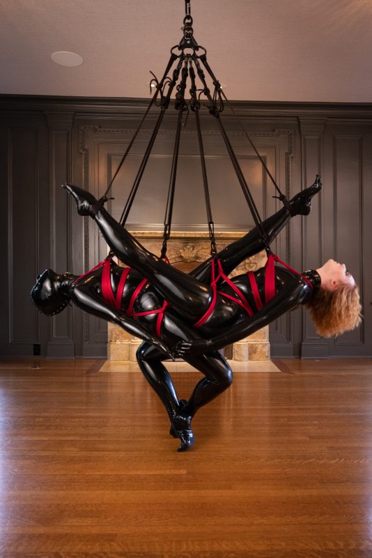 A sexy photograph of Alice, Vespa & Tie Rope Take Photo in black latex. Tagged with: rope / shibari. Posted June 2021.