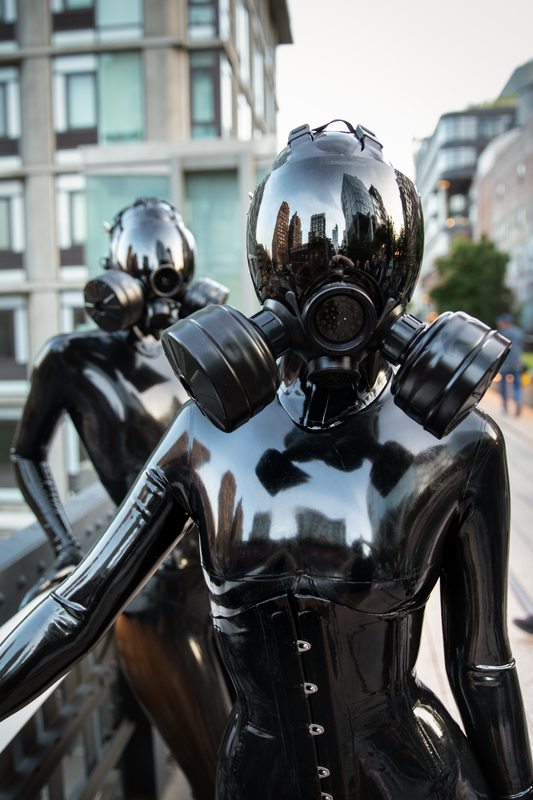 A sexy photograph of Vespa & Cam Damage, in black latex. Tagged with: in public & gasmask. Posted November 2019.