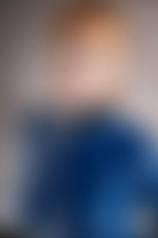 A sexy photograph of Emma Magnolia in blue latex. Posted October 2025.