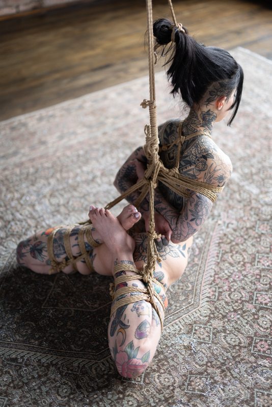 A sexy photograph of Awlivv showing bare skin. Tagged with: rope / shibari &amp; tattoos. Posted July 2025.