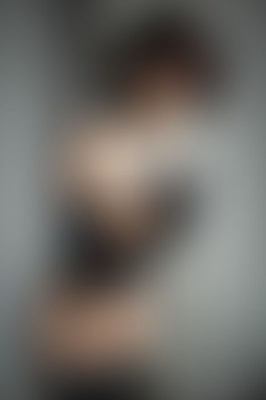 A sexy photograph of Ravyn Alexa showing bare skin with black latex. Posted May 2020.