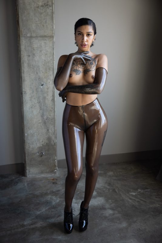 A sexy photograph of Ravyn Alexa, showing bare skin with transparent latex. Posted May 2021.