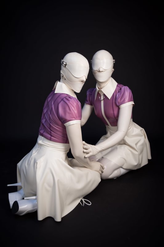 A sexy photograph of Vespa & Nico, in transparent, purple & pink & white latex. Posted December 2017.