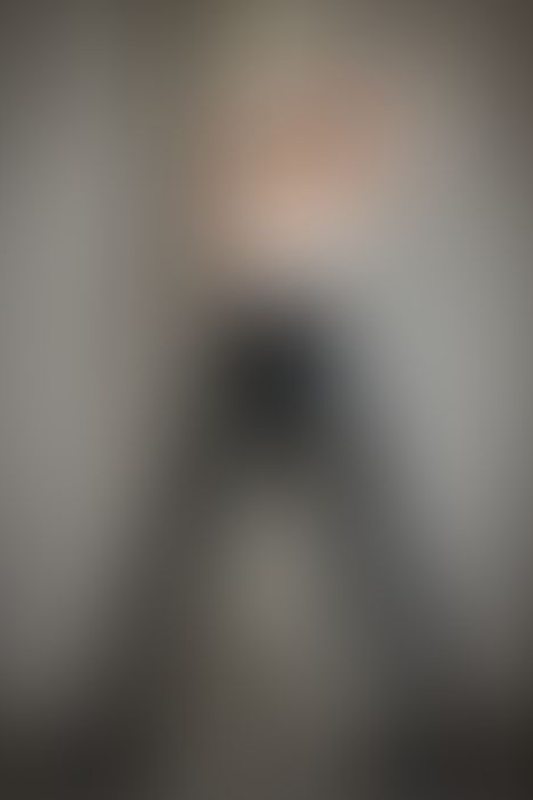 A sexy photograph of Charlee showing bare skin with black latex. Posted June 2021.