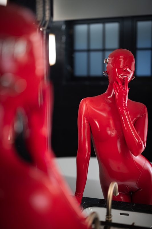 A sexy photograph of Glossy Toy in red latex. Posted March 2023.