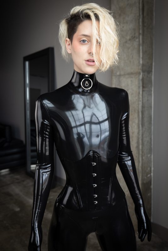 A sexy photograph of Cam Damage, in black latex. Posted July 2021.
