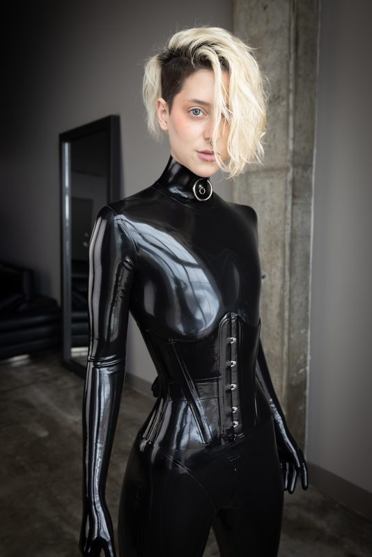A sexy photograph of Cam Damage in black latex. Posted July 2021.