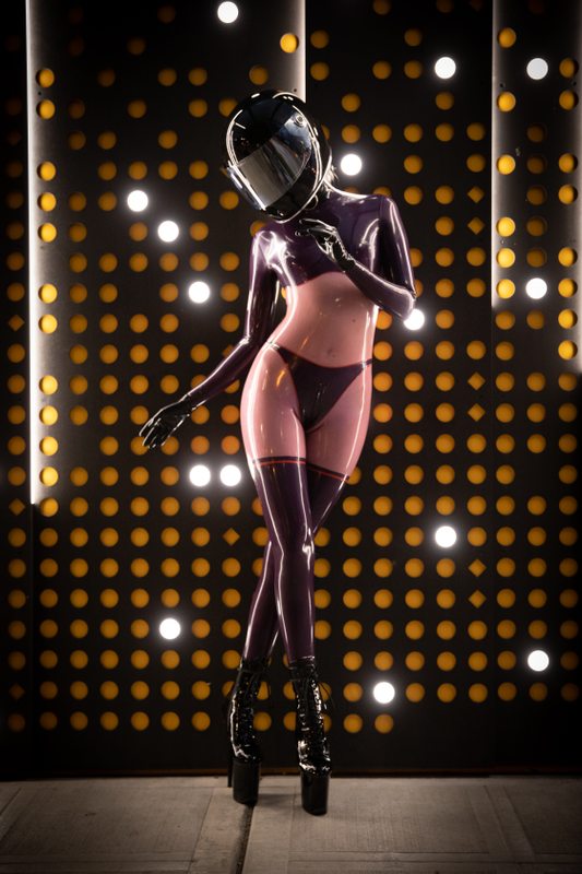 A sexy photograph of Glossy Toy in purple & pink & transparent latex. Tagged with: in public & moto helmet. Posted January 2020.