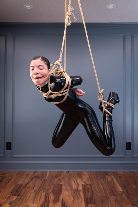 A sexy photograph of Shweetie, in black latex. Tagged with: rope & gagged. Posted December 2021.