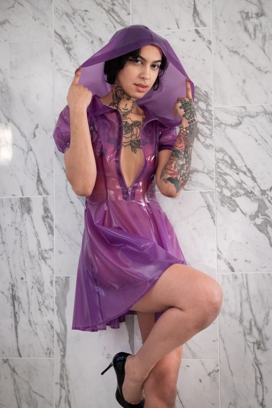 A sexy photograph of Ravyn Alexa in transparent & purple & pink latex. Posted May 2022.