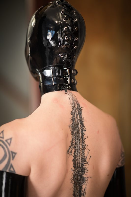 A sexy photograph of Cam Damage showing bare skin with black latex. Tagged with: tattoos. Posted January 2018.