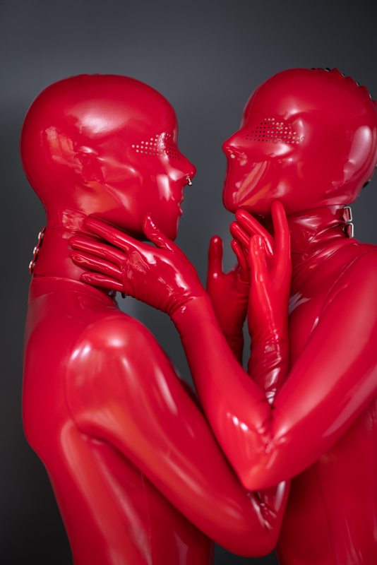 A sexy photograph of Cam Damage & Vespa in red latex. Posted April 2021.