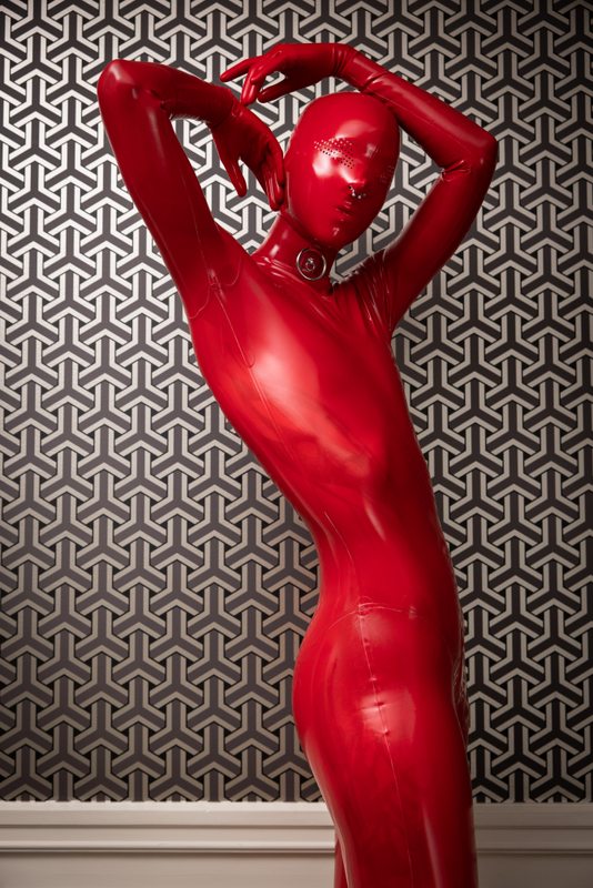 A sexy photograph of Cam Damage, in red latex. Posted April 2021.