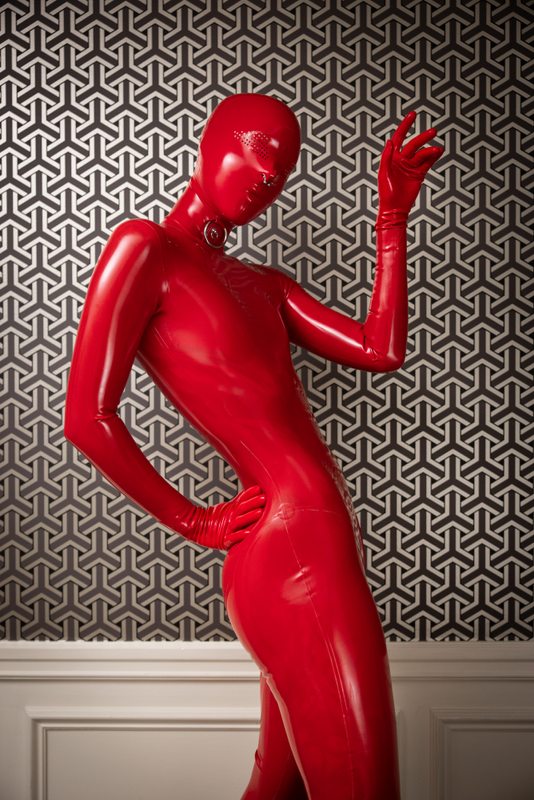 A sexy photograph of Cam Damage, in red latex. Posted April 2021.