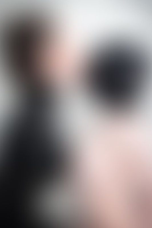 A sexy photograph of Vauntastic &amp; Chuck showing bare skin with black latex. Posted March 2023.