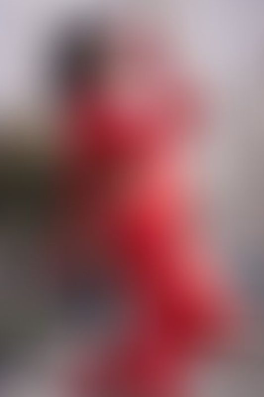 A sexy photograph of Awlivv in red latex. Tagged with: in public. Posted June 2025.