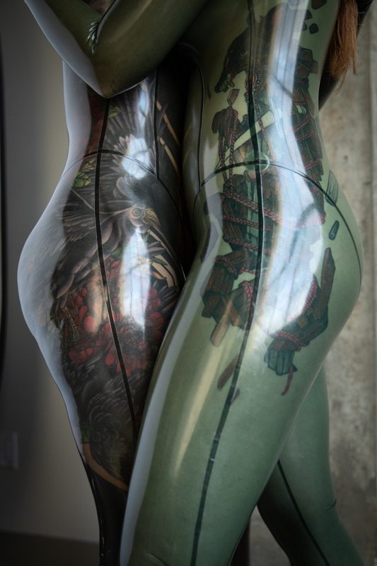 A sexy photograph of Nim Pup & Fire Rabbit, in transparent latex. Tagged with: tattoos. Posted February 2020.