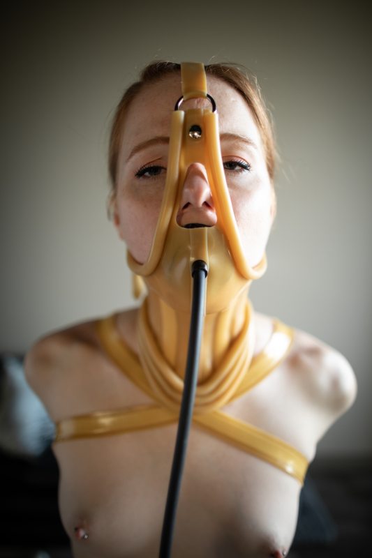 A photo album of Mbot showing bare skin with transparent latex. Tagged with: gagged, armbinder & rope / shibari. Posted January 2020.