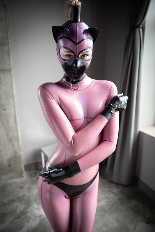 A sexy photograph of Defiantly Yours in transparent & purple & pink latex. Tagged with: kitten. Posted April 2020.