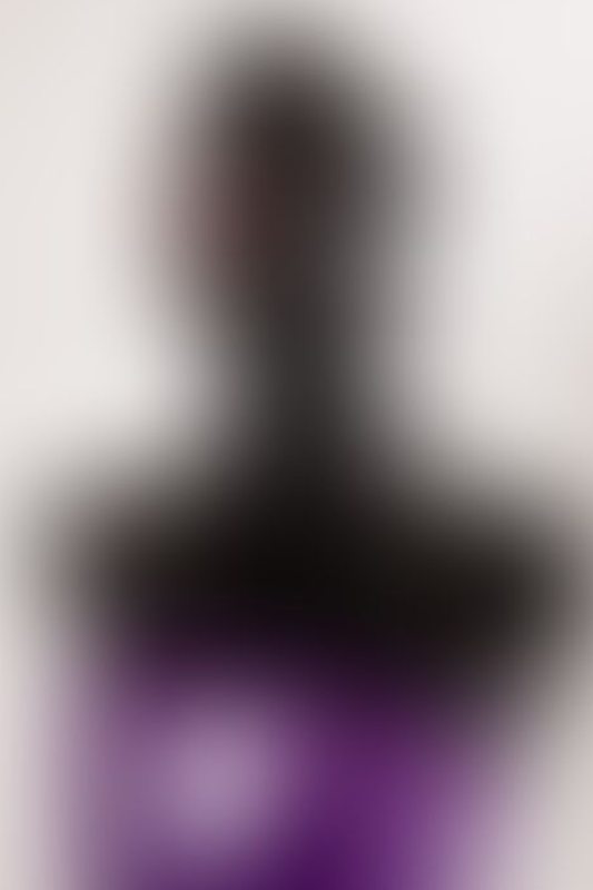 A sexy photograph of Cam Damage in purple & pink latex. Tagged with: gags &amp; armbinder. Posted March 2018.