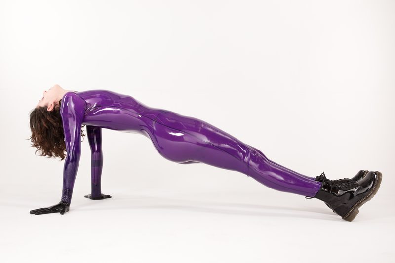 A sexy photograph of Cam Damage in purple & pink latex. Posted March 2018.