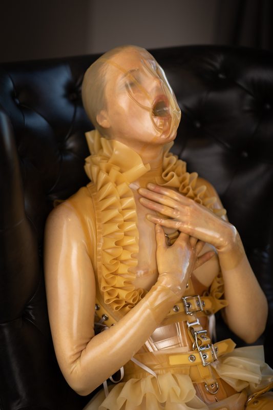 A photo album of Mbot in transparent latex. Tagged with: gagged, neck corset & breath play. Posted December 2020.