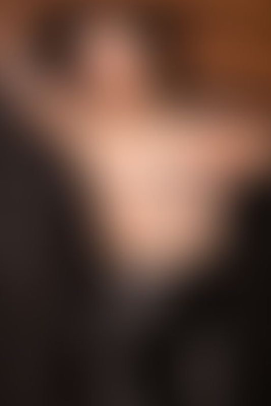 A sexy photograph of Shweetie showing bare skin with black latex. Posted September 2021.