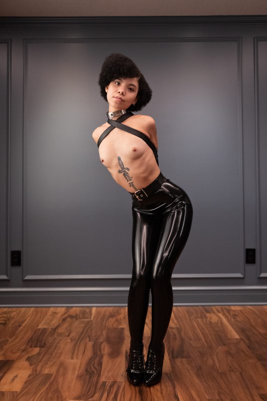 A sexy photograph of Shweetie showing bare skin with black latex. Tagged with: armbinder. Posted September 2021.