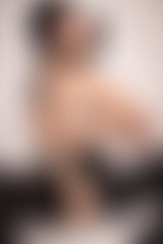 A sexy photograph of Shweetie showing bare skin with black latex. Posted September 2021.