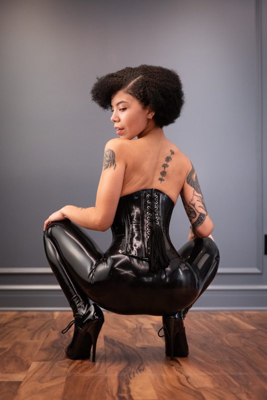 A sexy photograph of Shweetie showing bare skin with black latex. Posted September 2021.