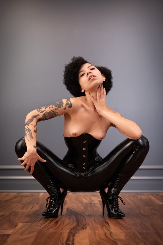 A sexy photograph of Shweetie showing bare skin with black latex. Posted September 2021.