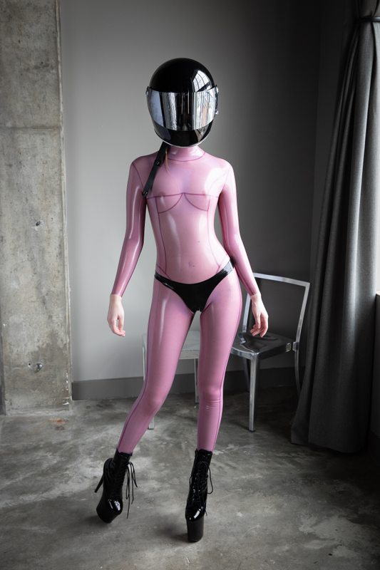 A sexy photograph of Defiantly Yours, in purple & pink latex. Posted May 2020.