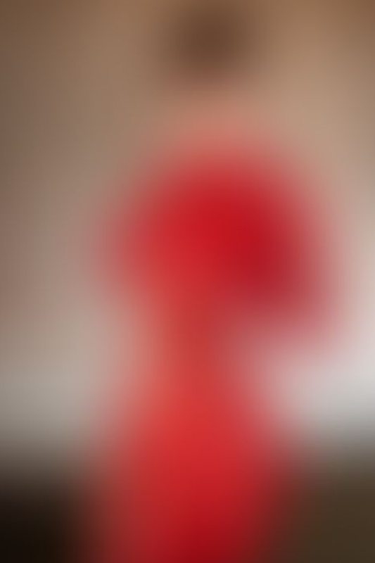 A sexy photograph of Succubunnyy in red latex. Posted August 2025.