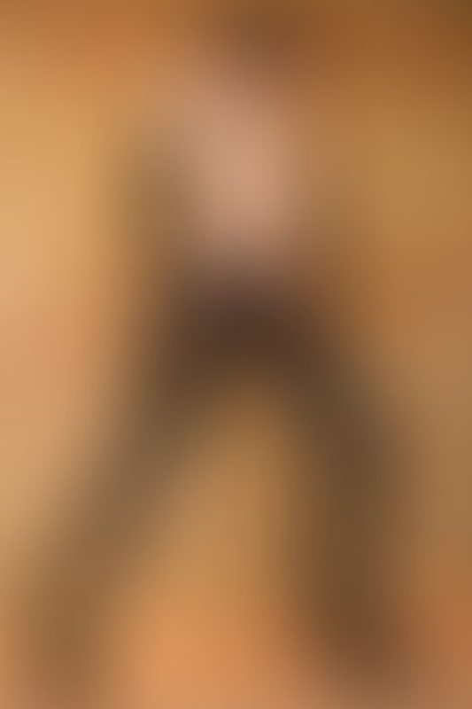 A sexy photograph of Knotasha showing bare skin with black latex. Posted January 2018.
