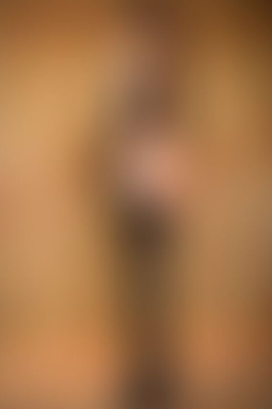 A sexy photograph of Knotasha showing bare skin with black latex. Posted January 2018.