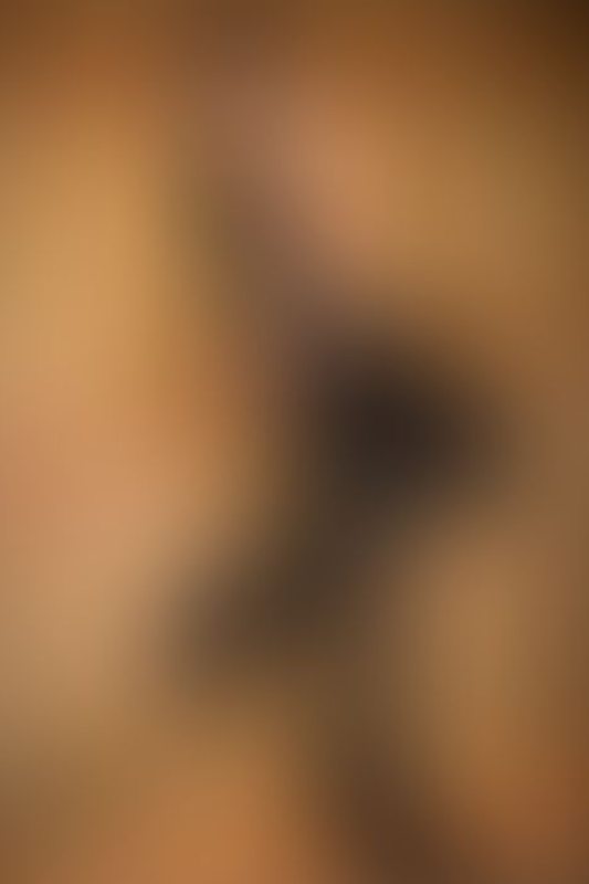 A sexy photograph of Knotasha showing bare skin with black latex. Posted January 2018.