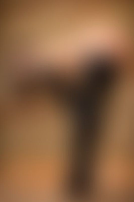 A sexy photograph of Knotasha showing bare skin with black latex. Posted January 2018.
