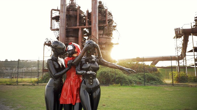 A sexy video of Vespa, Rope Candy & Nico in black & red latex. Tagged with: gasmask, in public & corset. Posted October 2017.